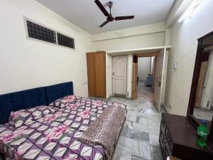 a bedroom with a bed and a ceiling fan at Aijaz Arcade in Hyderabad