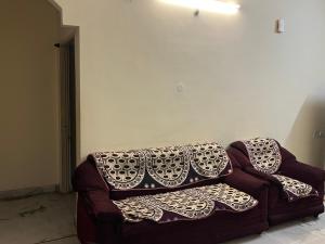a couch with pillows on it in a living room at Aijaz Arcade in Hyderabad