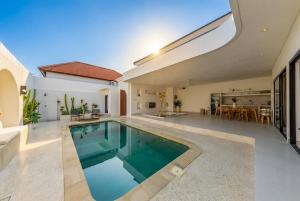 a swimming pool in the middle of a house at Nirvana Canggu 2BR Near Berawa in Mantaak