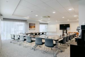 a conference room with a long table and chairs at Punthill Essendon in Melbourne