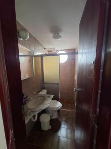 a bathroom with a sink and a toilet and a mirror at Apartmento Moto GP in Goiânia +8 photos