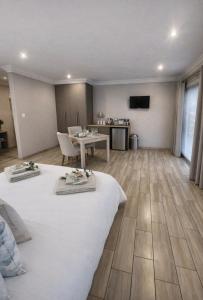 a hotel room with two beds and a table at Bella Rosa in Potchefstroom