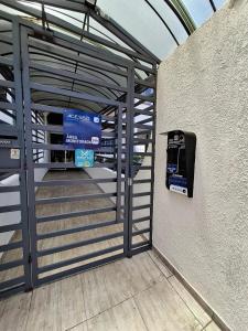 a metal gate leading into a parking garage at Apartmento Moto GP in Goiânia