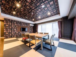 a conference room with a table and chairs and a tv at Lieta Nakayama in Nago