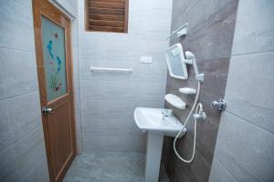 a bathroom with a sink and a mirror at River Shade Inn in Tissamaharama +35 photos