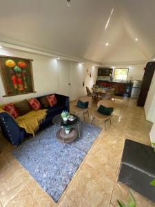 a living room with a couch and a table at Dreamvilles Ecovillage Eco Villas with Jacuzzi near Beaches in Las Galeras