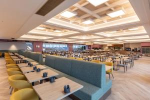 a large dining room with tables and chairs at KAMENOI HOTEL Kusatsu Resort in Kusatsu