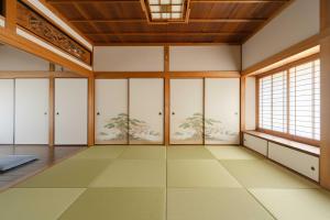 an empty room with white walls and windows at NODOKA Awajishima in Minamiawaji