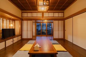 a living room with a wooden table and a tv at NODOKA Awajishima in Minamiawaji +71 photos