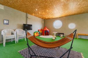 a hammock in a room with a play room at NODOKA Awajishima in Minamiawaji