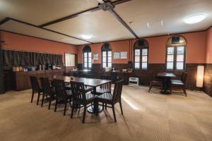 a dining room with a table and chairs at Adamo Akakura in Myoko