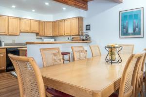 a kitchen and dining room with a wooden table and chairs at Riverside Condos D02 condo in Telluride