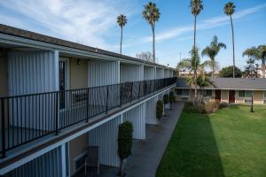 a balcony view of a building with palm trees at Quality Inn & Suites Santa Maria in Santa Maria