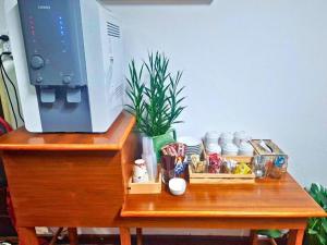 a wooden table with a desk with a computer on it at Hotel De Ratt in Phuket