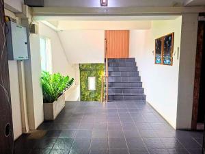 a hallway with a staircase in a building at Hotel De Ratt in Phuket