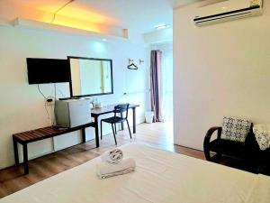 a room with a bed and a table with a mirror at Hotel De Ratt in Phuket +16 photos