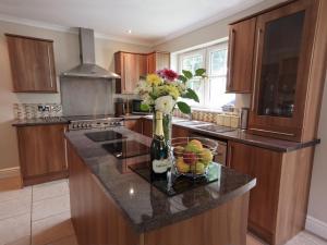 a kitchen with a counter with a vase of flowers at Four Seasons - Hw7432 in Tal-gareg +21 photos