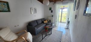 a living room with a couch and a table at Horizon studio apartment in Palaiokatoúna