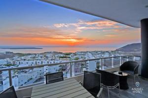 a view of a city from a balcony with a sunset at Gated Community Oceanview Condo Pool & Gym in La Paz