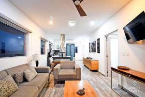 a living room with a couch and a tv at Gated Community Oceanview Condo Pool & Gym in La Paz