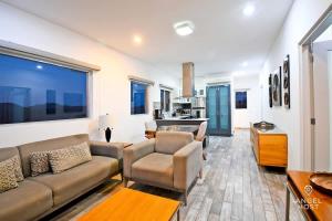 a living room with a couch and a table at Gated Community Oceanview Condo Pool & Gym in La Paz