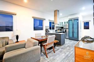 a kitchen and living room with a table and chairs at Gated Community Oceanview Condo Pool & Gym in La Paz +31 photos