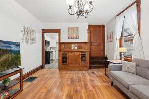 a living room with a couch and a tv at Spacious 2BR Across from Como Lake - Bramble in Saint Paul