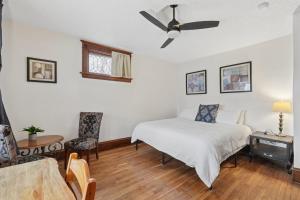 a bedroom with a bed and a ceiling fan at Spacious 2BR Across from Como Lake - Bramble in Saint Paul +20 photos