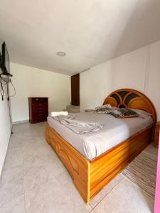 a bedroom with a wooden bed in a room at Villa bella Claudia in Armenia