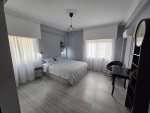 a bedroom with a bed and a table and a chair at Beach apartments in Limassol