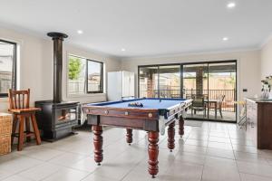 a living room with a pool table and a stove at Paradise Point Cowes in Cowes