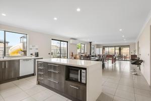 an open kitchen and dining area of a house at Paradise Point Cowes in Cowes