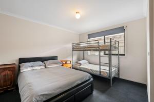 a bedroom with a bed and a bunk bed at Paradise Point Cowes in Cowes
