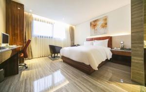 a hotel room with a bed and a desk at First Hotel in Guri +54 photos