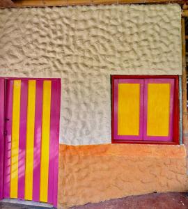 two windows on the side of a building at Villa bella Claudia in Armenia