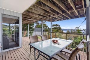 a patio with a table and chairs on a deck at Scelta in Lorne