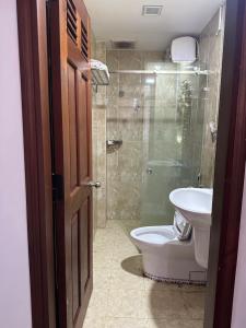 a bathroom with a toilet and a sink and a shower at MAY HOMESTAY Villa in Hue +17 photos