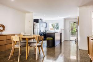 a kitchen with a table and chairs in a room at Relax at 42 Cape View Resort in Broadwater