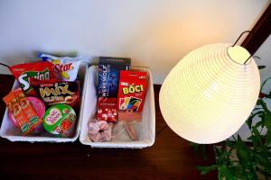 a table with some snacks and a lamp and a lamp at Pavillon D'Hue Homestay in Hue +49 photos