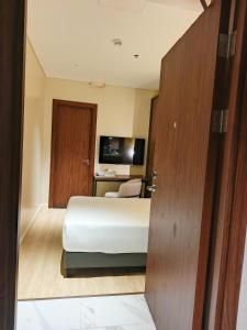 a hotel room with a bed and a desk at Hotel George in Cebu City