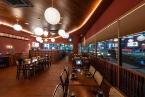 a dining room with tables and chairs and lights at 원주 시티호텔 혁신도시점 in Wonju