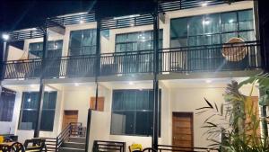 a white building with balconies on the side of it at Cuna Del Alri in Samal +5 photos