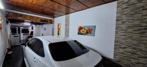 a white car is parked in a garage at Paseo Dean Funes Dúplex in San Rafael