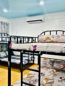 a room with two bunk beds on the floor at Cuna Del Alri in Samal