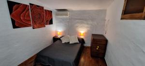 a small room with a bed and two night stands at Paseo Dean Funes Dúplex in San Rafael