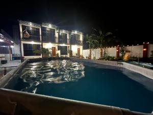 a swimming pool in front of a house at night at Cuna Del Alri in Samal