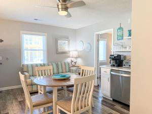 a kitchen and dining room with a table and chairs at North Cape- Behing Trading Post - Pet Friendly in Cape San Blas