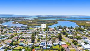 an aerial view of a suburb with a church at La Dolce Vita - Your next coastal getaway in Caves Beach
