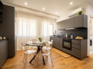 a kitchen with a table and chairs in a kitchen at Sparano Mood 170 in Bari