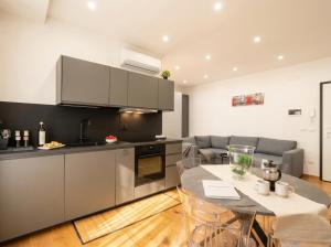 a kitchen with stainless steel appliances and a table at Sparano Mood 170 in Bari